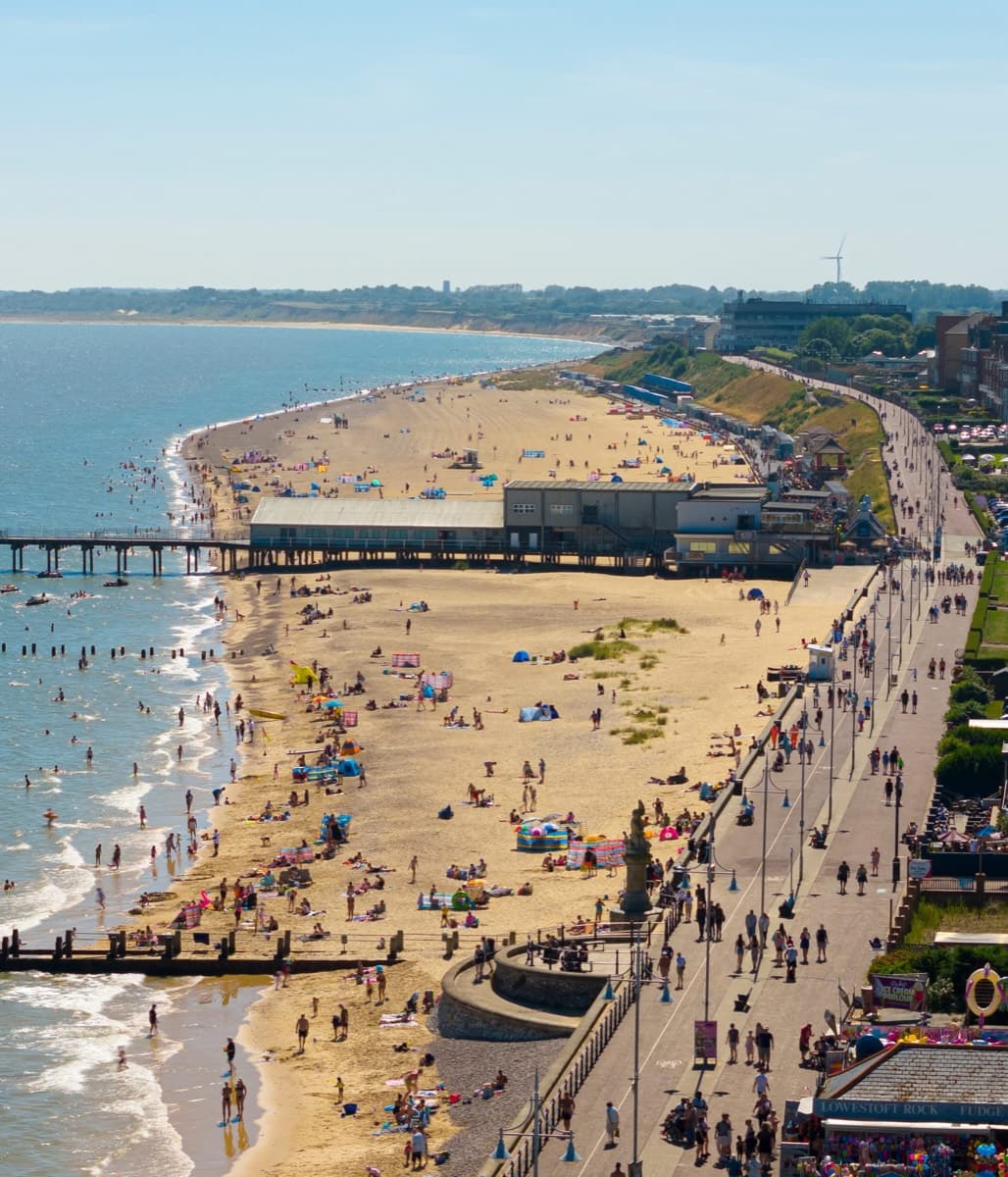 Aerial view of a busy Lowestoft beach and promenade on a sunny summer day